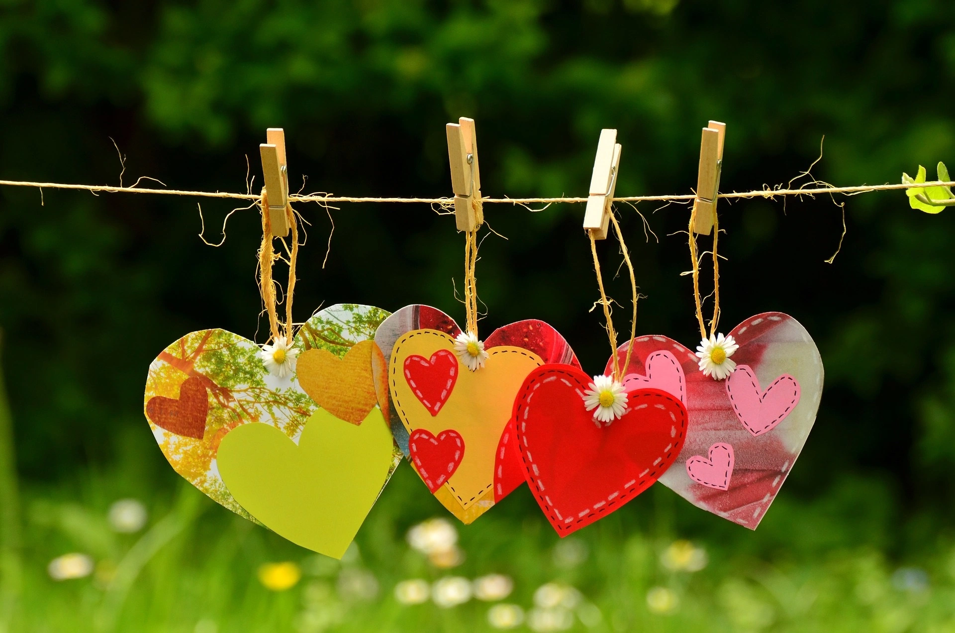 Four craft love hearts pegged on a line of string