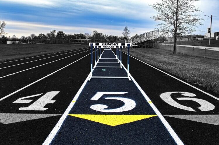 Hurdles track lanes disappearing into the background