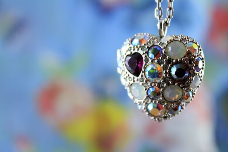 A multi jeweled metal heart-shaped locket